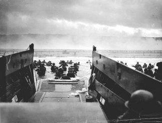 U.S. troops on D-Day at Omaha Beach. | Public domain; official U.S. Coast Guard photograph