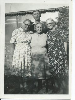 My great grandmother Minnie in the middle standing in front of her husband George. I'm assuming that both the women standing either side of her are her sisters, Annie and Lizzie (Eliza) photo taken obviously before George's death in June 1951. Photo taken in Newcastle, NSW Australia.