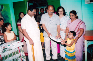 Dr Ram presenting uniform, wife Rema, teachers & pupils. Dr Rams daughters Ratheetha & Remina pictured far left. | Dr Ram